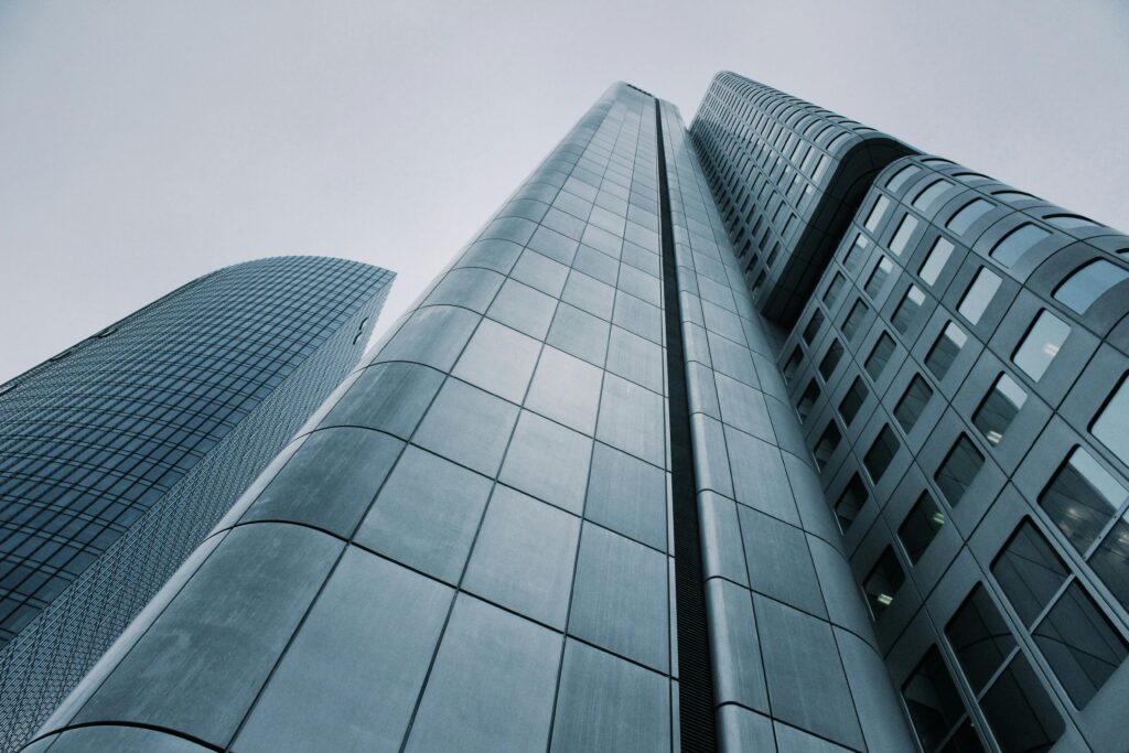 pexels-photo-273209-273209 Low angle view of modern skyscrapers with glass and steel design. Perfect for corporate imagery.